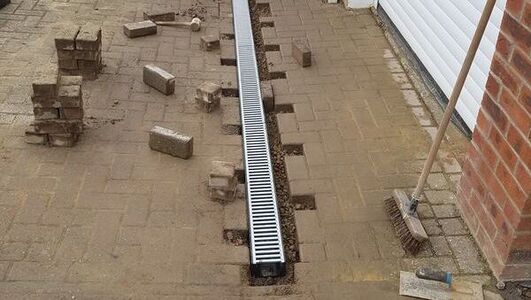 ACO drainage channel installation for a block paving driveway